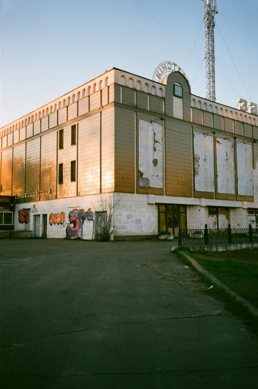 an old building sitting in front of a tall television tower