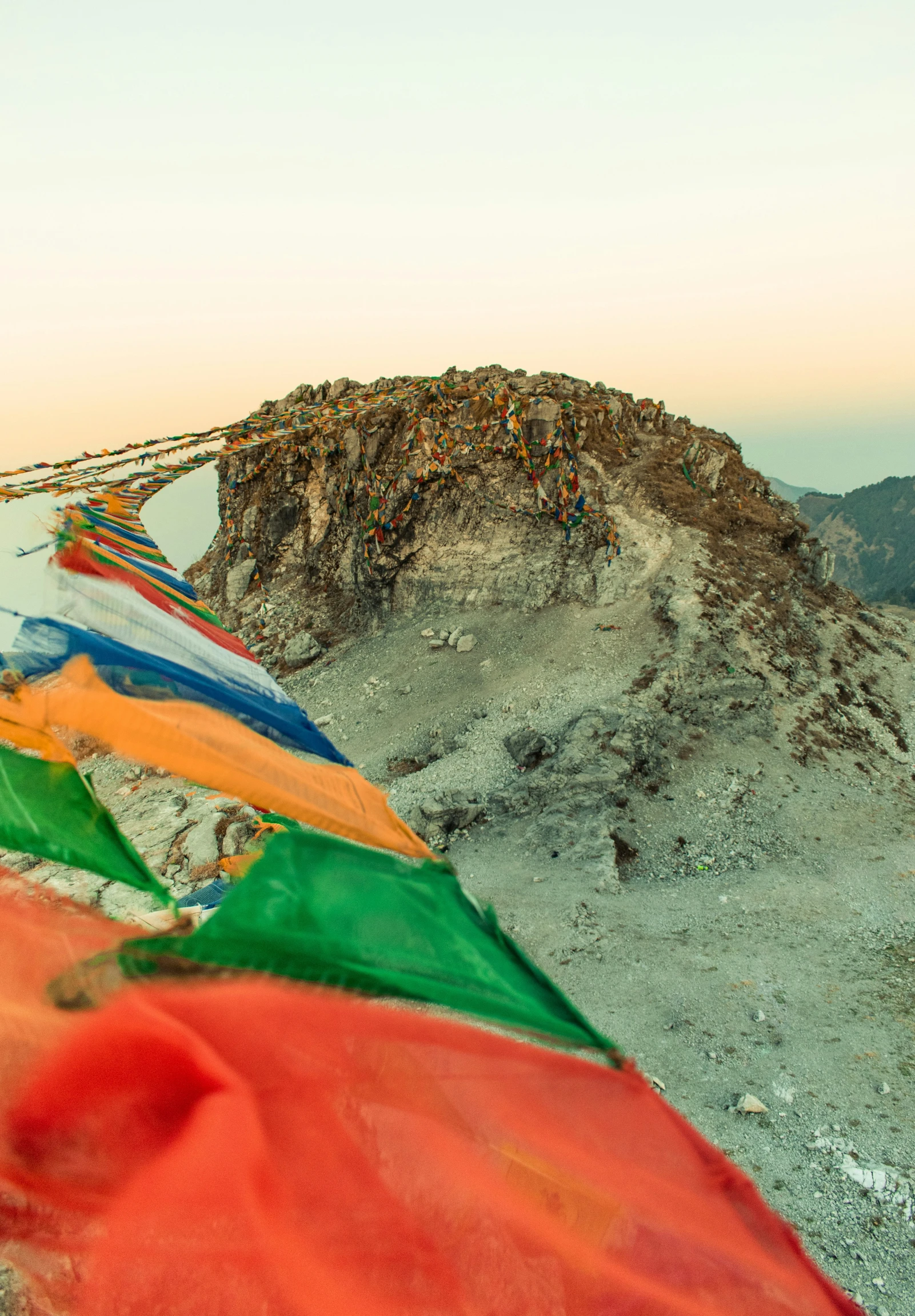 a big mountain has many colorful flags on it