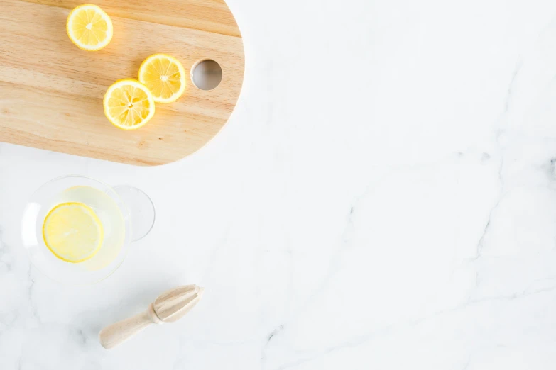 a table topped with a sliced up orange next to a glass