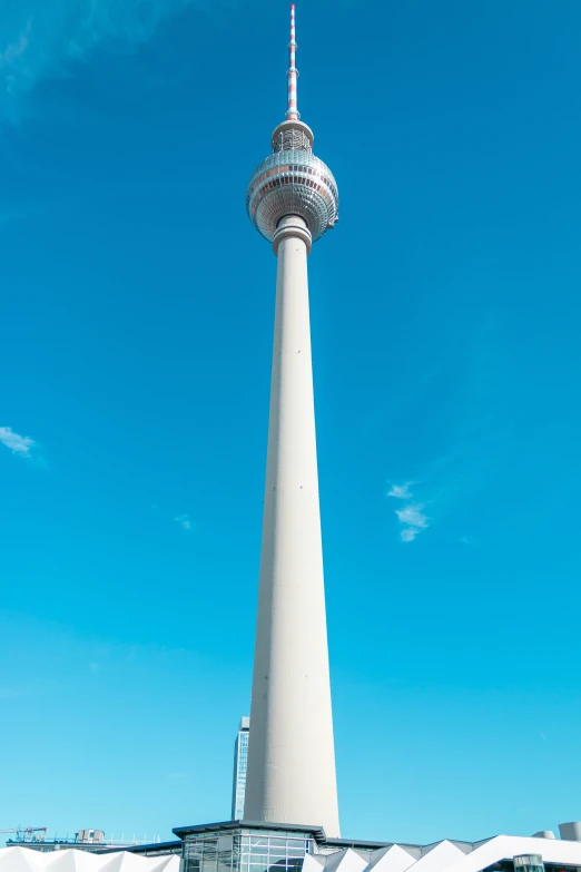 the spire of a tall building has a clock at its top