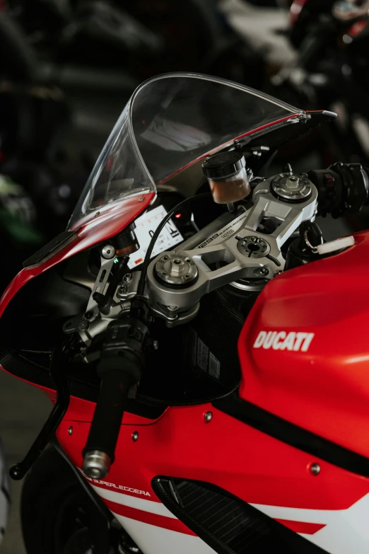 a closeup po of a red and white motorcycle