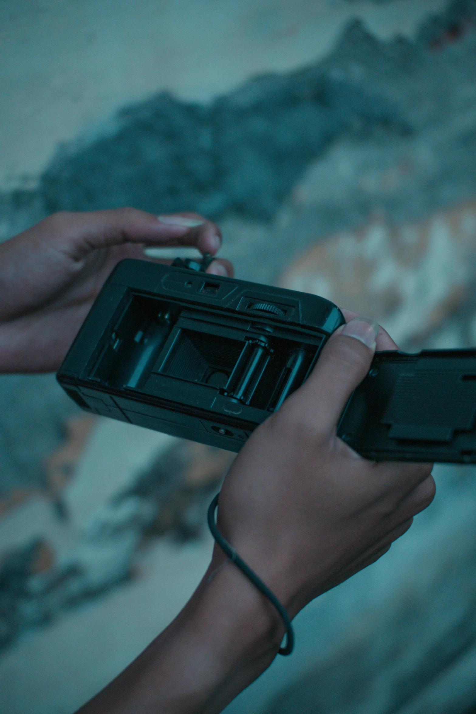 a camera being held in one hand by another in the other