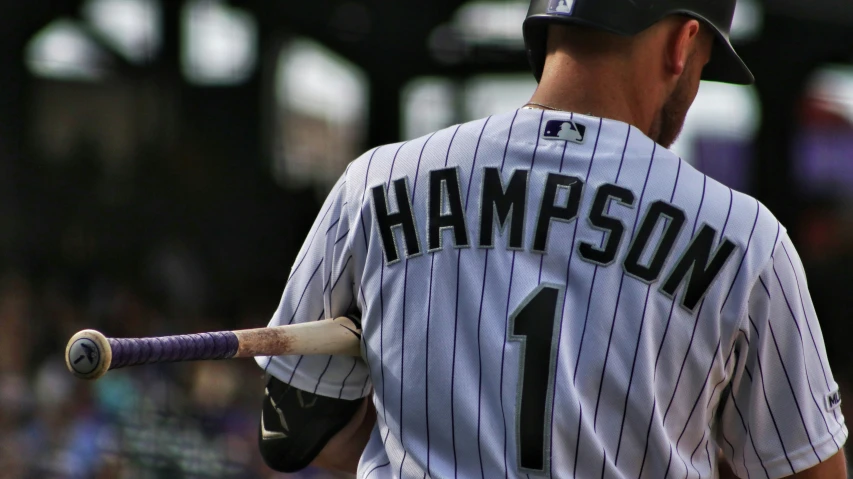 a baseball player holding a bat during a game