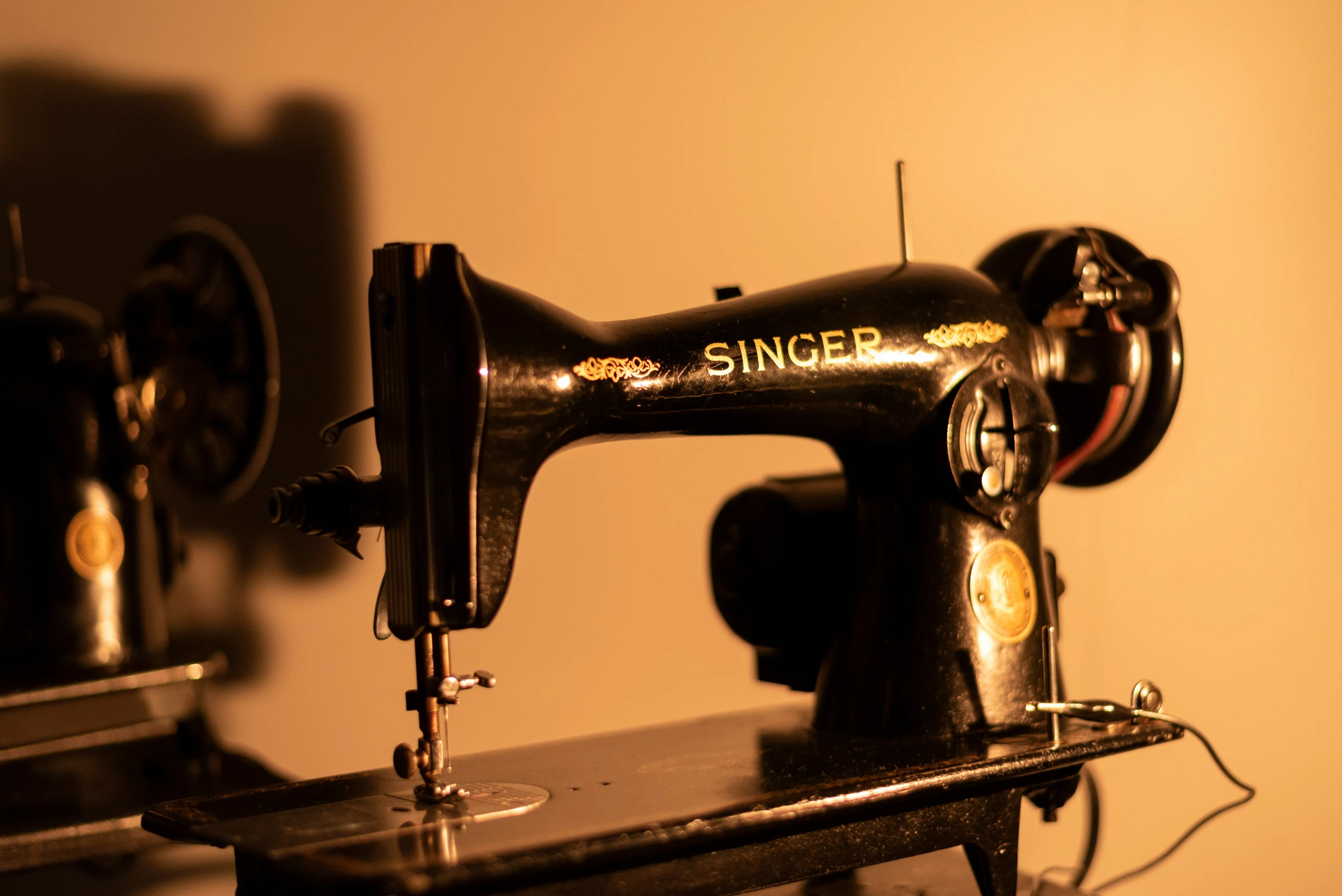 a black sewing machine sits on a shelf