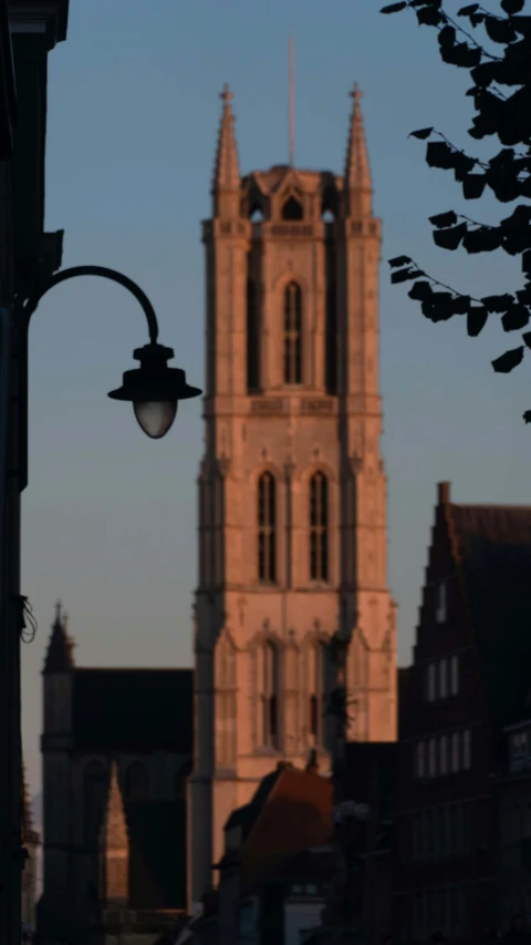 a very tall building with a big clock tower next to it