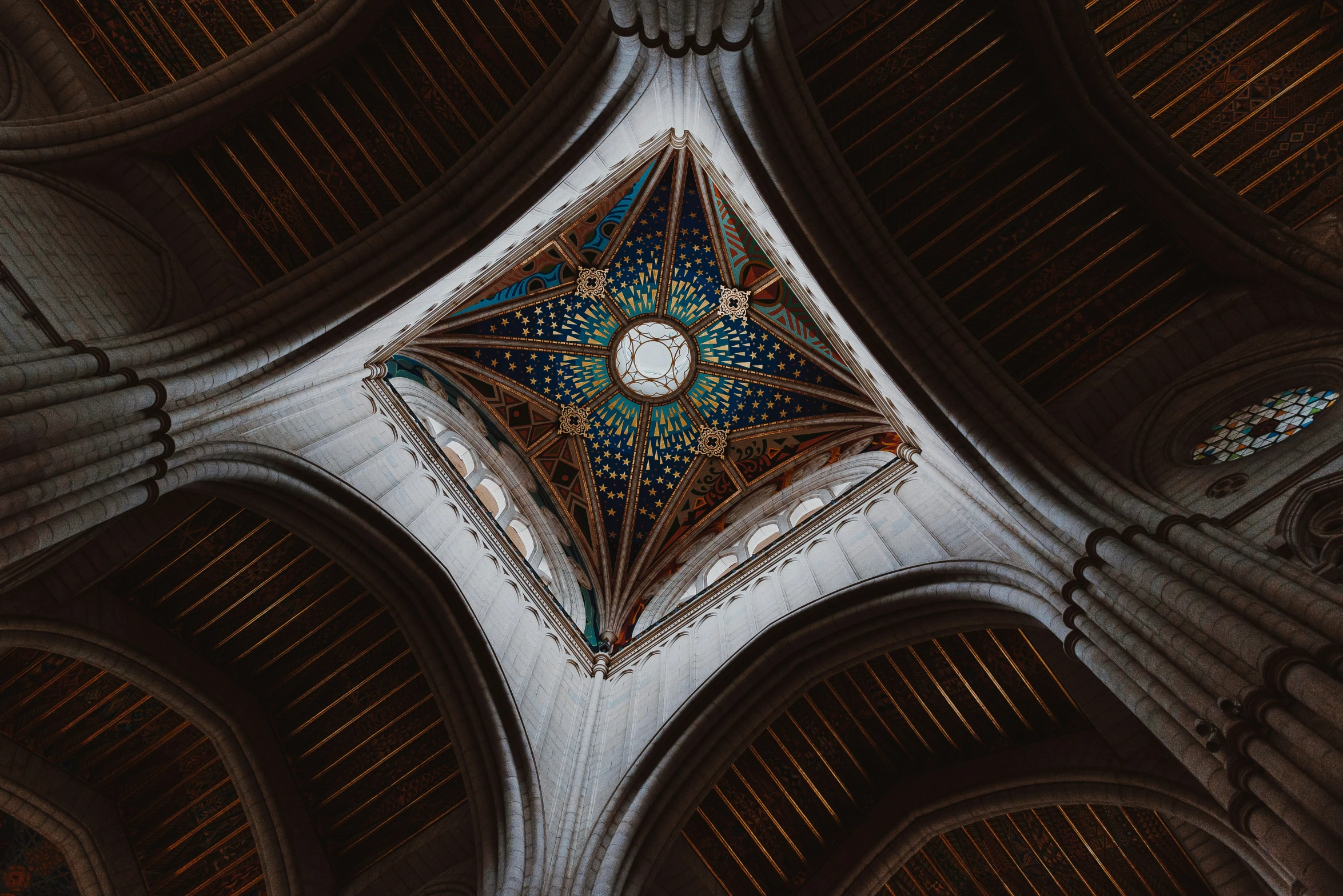 the ceiling of a cathedral is made up of intricate designs