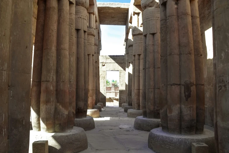 a wide hallway that has several statues on it