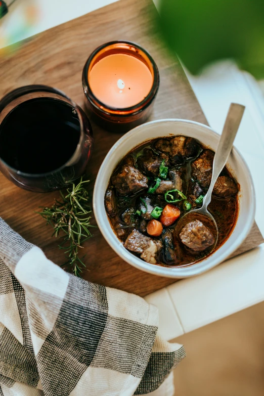 a soup bowl with meat and vegetables on a table