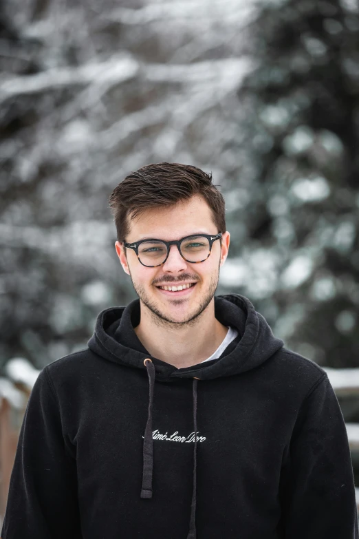 a man with a smile on his face and glasses