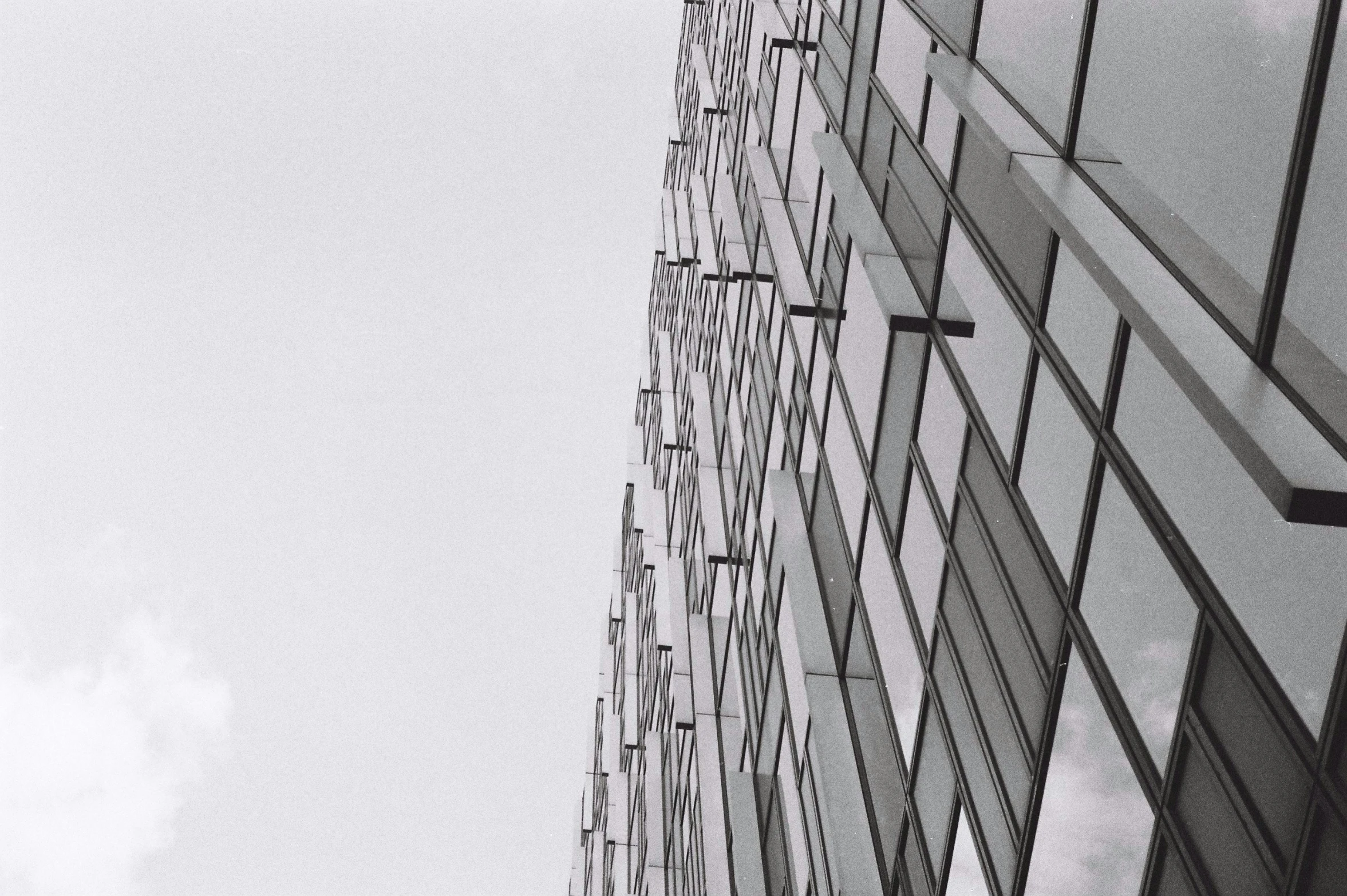 black and white pograph of a tall building with glass windows