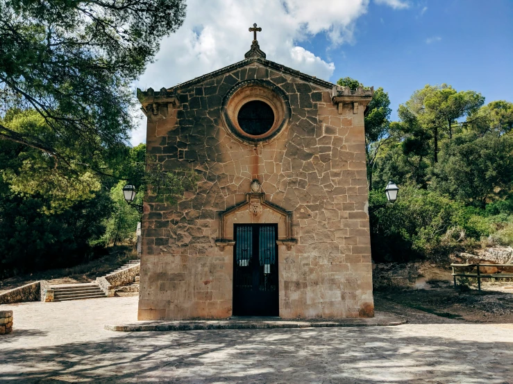 a brown building with a cross at the top and windows