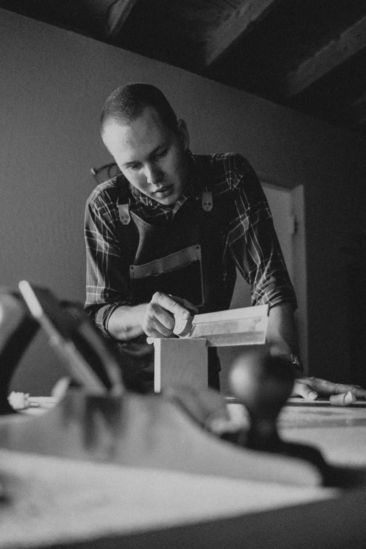 a man is working with some tools in the dark