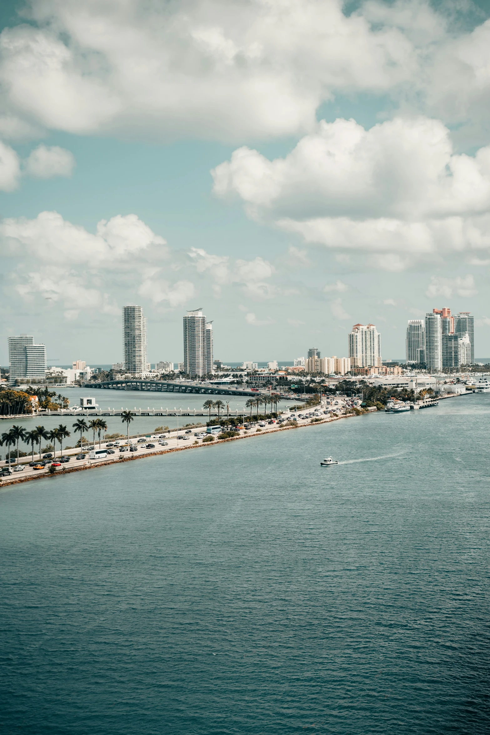 a body of water with a group of buildings in the background