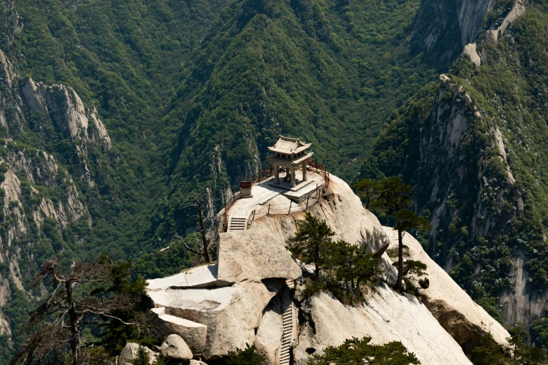 the rock tower is situated on top of a mountain