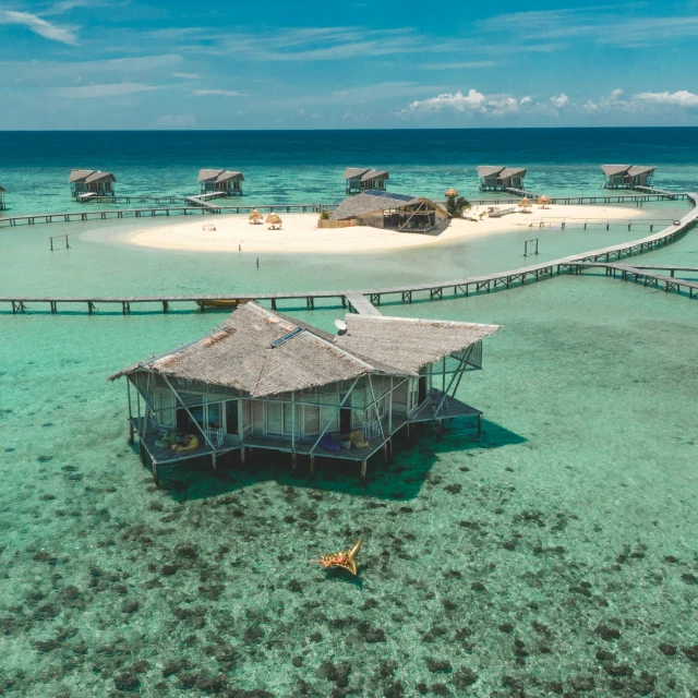 the beach side pier leads to several huts