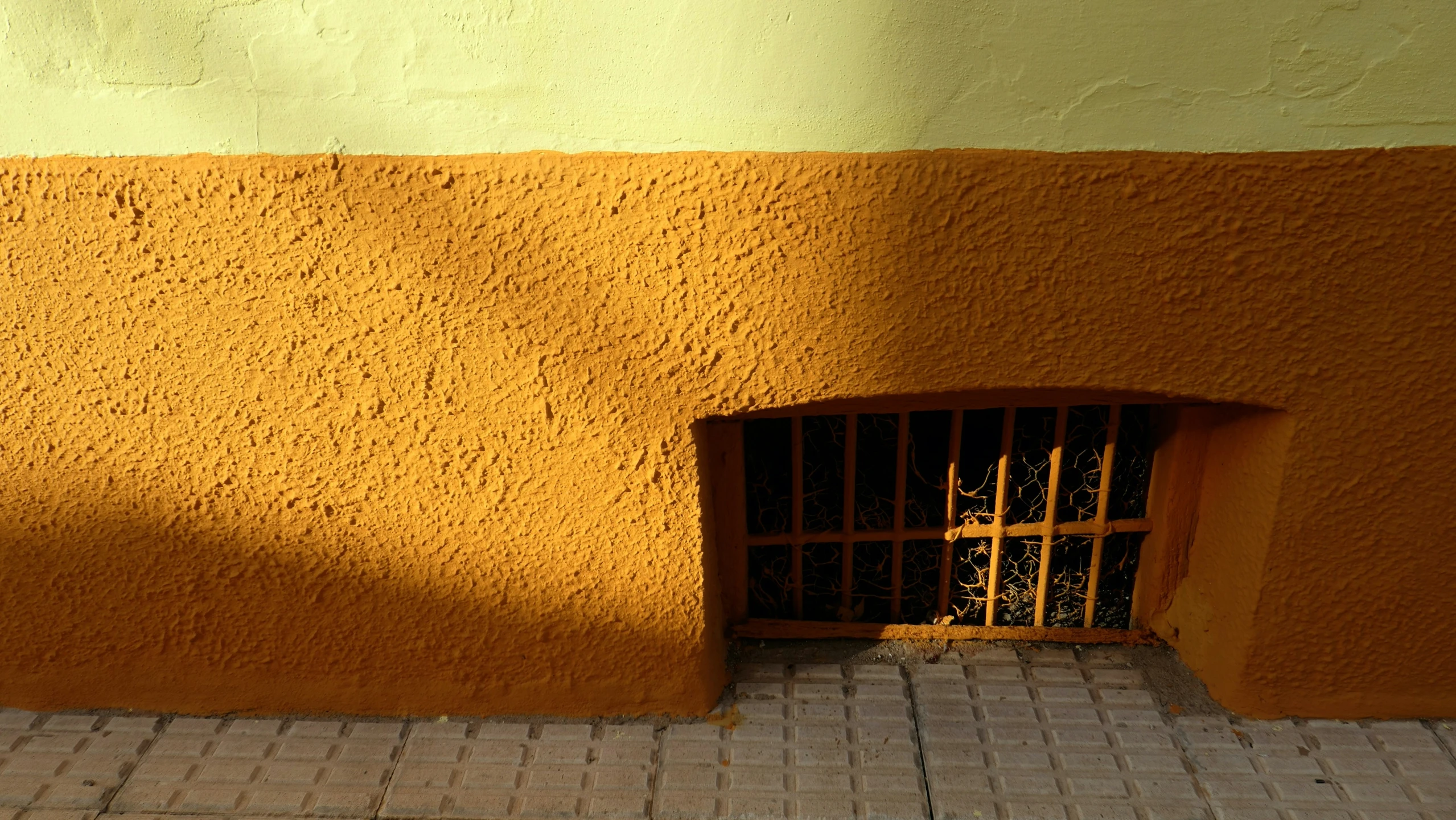 the brick area of the building is shaded by orange and yellow walls