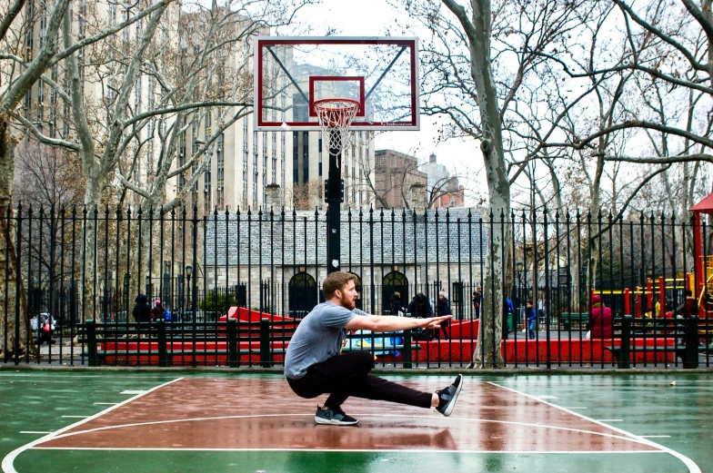 man doing his own trick while playing basketball