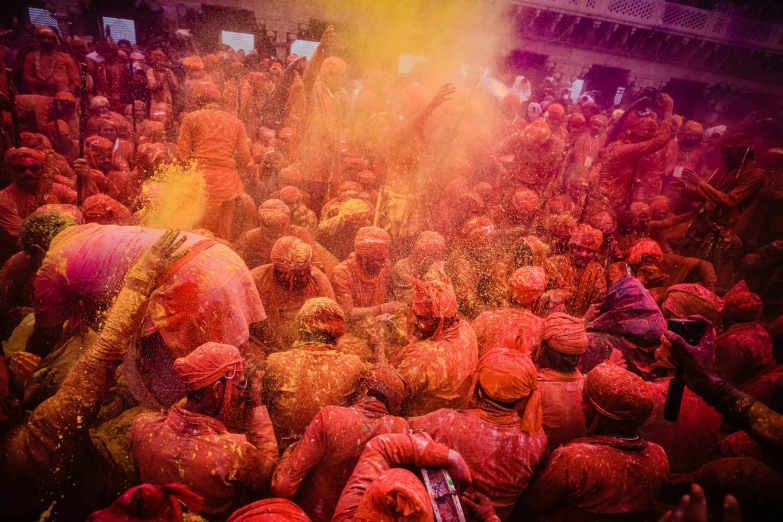 people covered in colored powder and water are celeting holi