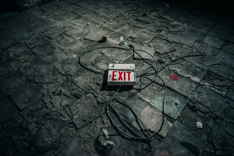 a red exit sign laying on the ground