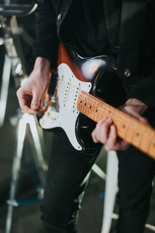 a person is playing guitar in a band