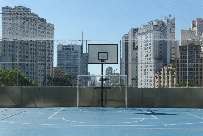 a basketball court with an overhead net in the city