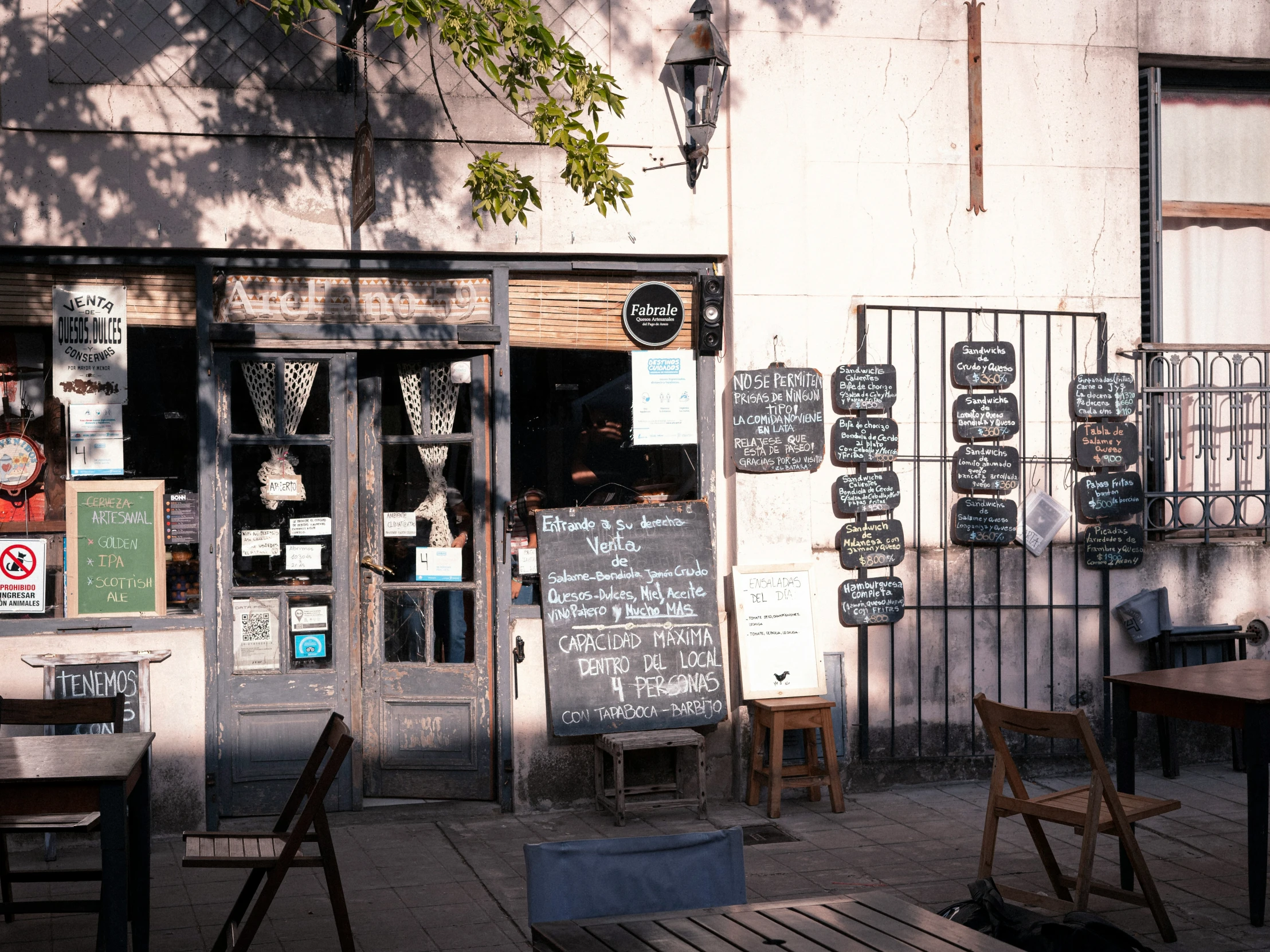 some chairs and tables in front of a building