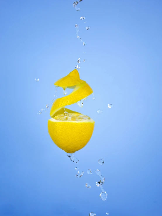 an orange that is being dropped into the water