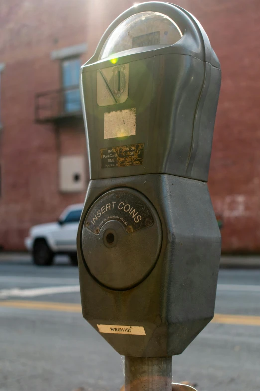 an old parking meter in front of a building