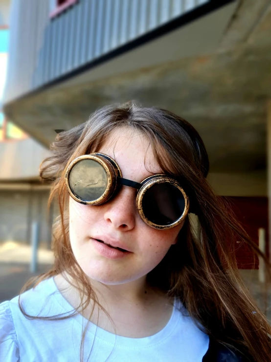 a close up of a young child wearing large pair of glasses