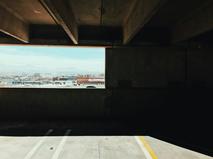 the view from inside an abandoned looking parking garage