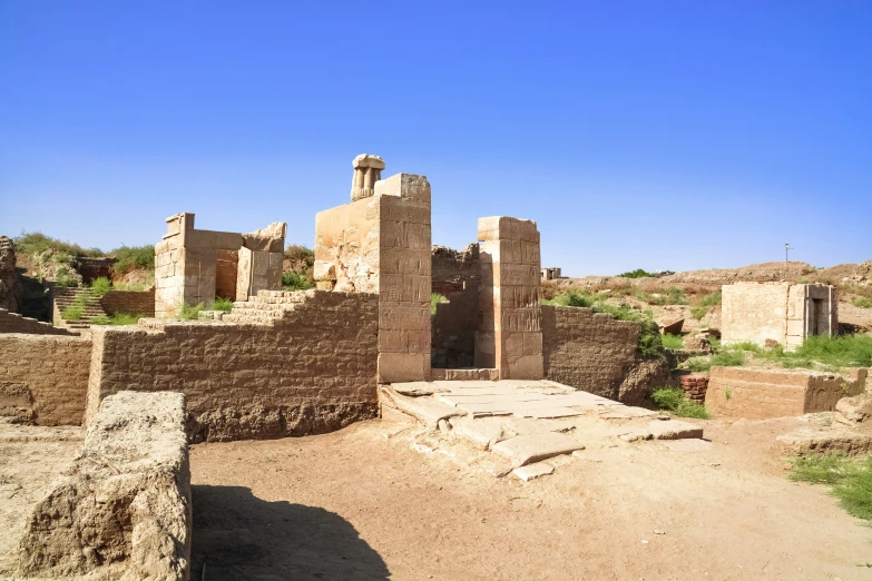 a stone and stucco building stands near a grassy field