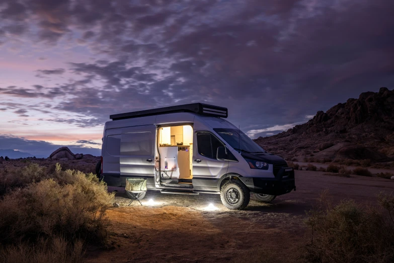 an rv with an outhouse attached to it sits in the desert