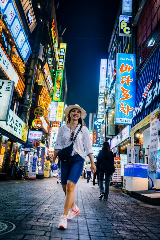 woman walking down the street in an asian city at night