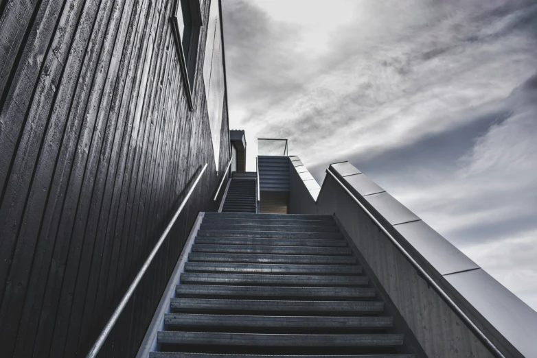 a view of stairs leading to an elevator going down