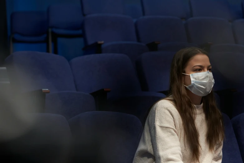 a girl wearing a face mask on her face