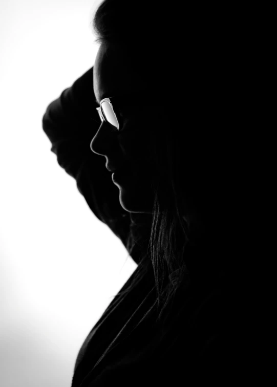 a woman with glasses in a silhouette