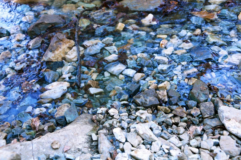 a rock filled river bed in the daytime