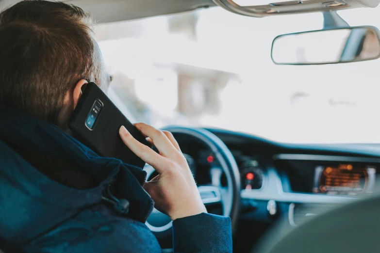 a woman driving in a car while talking on a cell phone