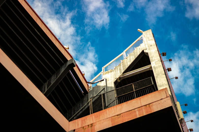 looking up at the walkway and roof of an overpass