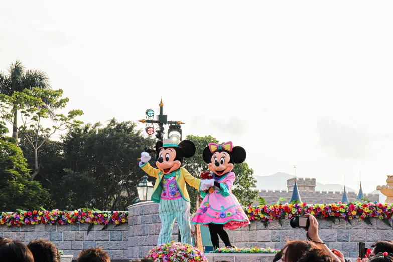 mickey and minnie dancing on top of the castle