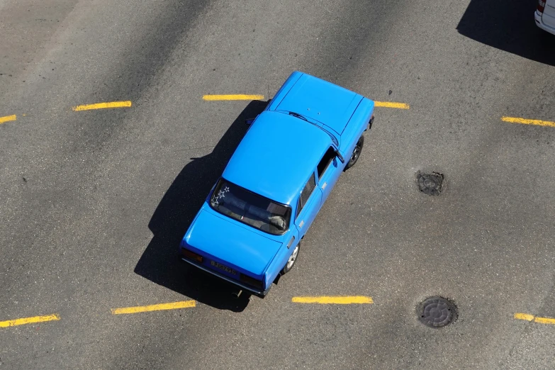 a bright blue mustang parked in front of a red car
