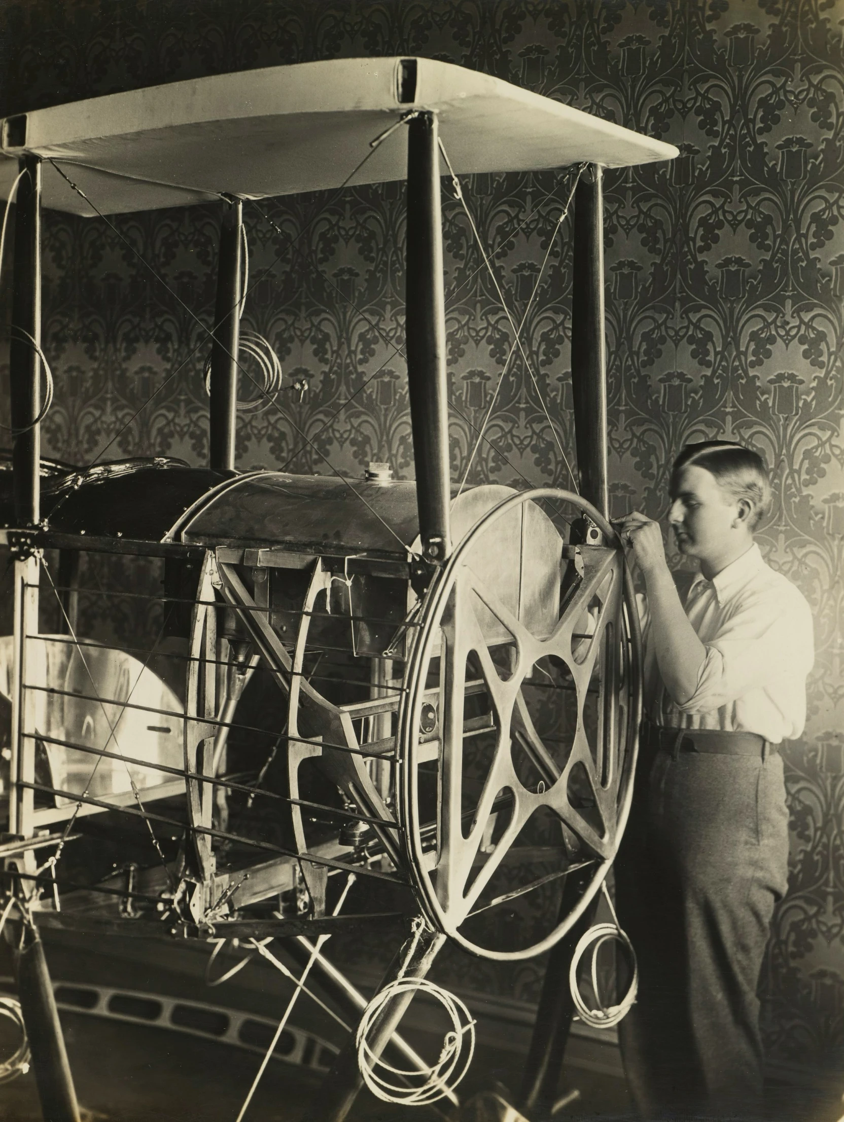 a vintage po shows a man in front of a spinning machine