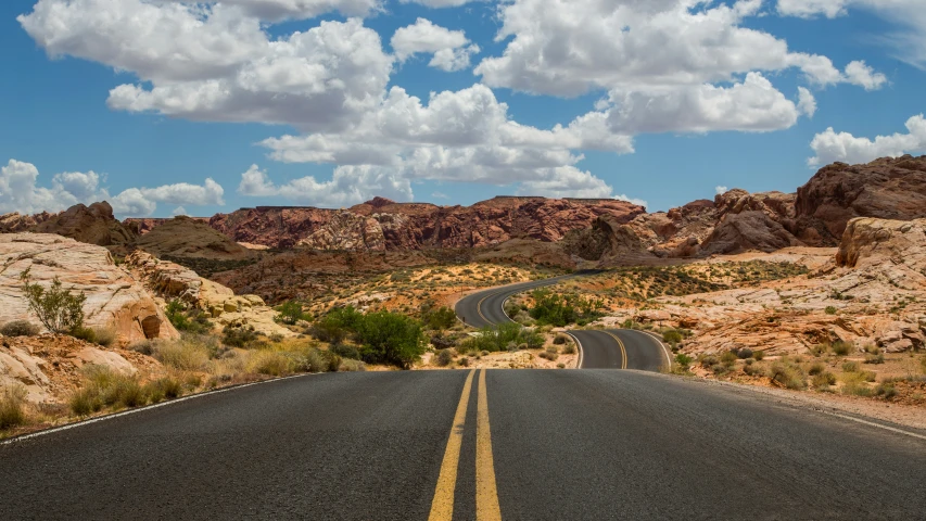 a view from the top of a road with a mountain in the background