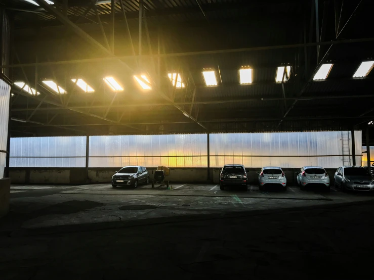 an empty parking garage with some cars parked in it