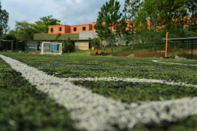 the view of a sports field from behind the goal