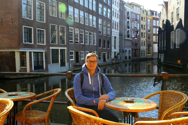 an image of a man sitting at a table outside