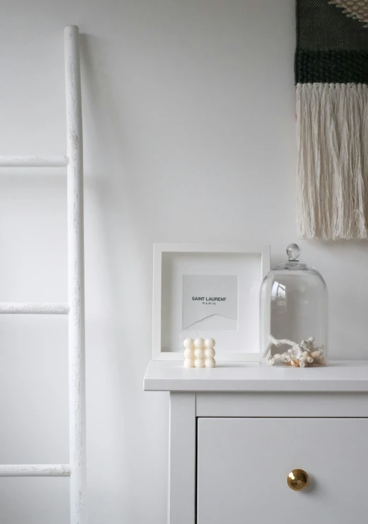 a shelf with a picture, candles and candles on it