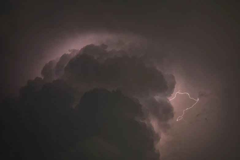 a storm is in the distance with a very big cloud