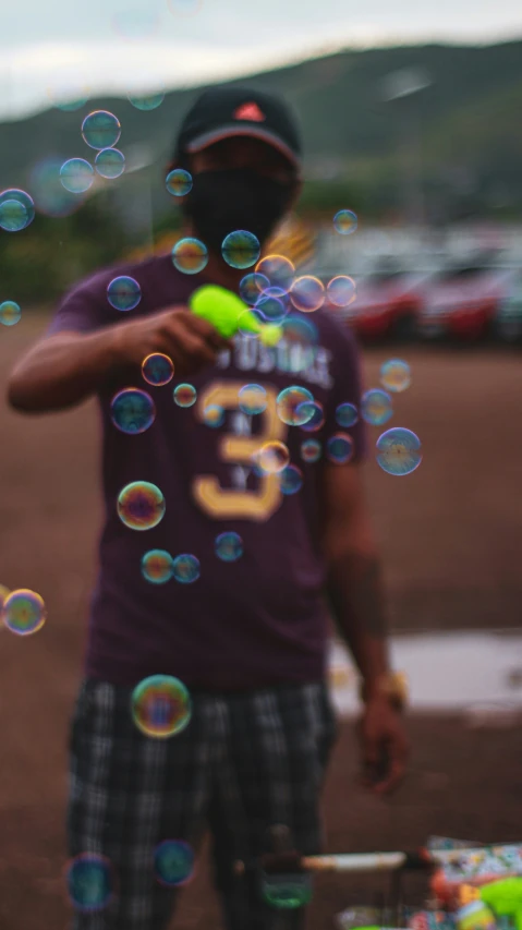 a person standing outside and blowing bubbles around him
