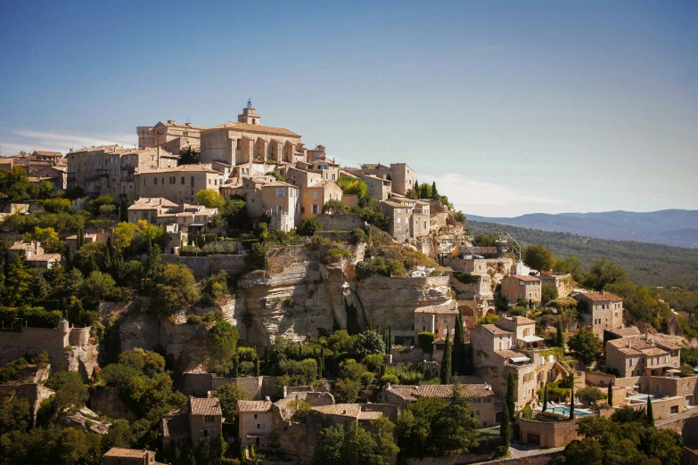 an old village built on a cliff with trees